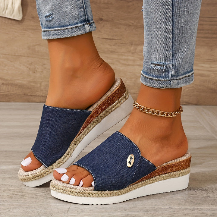 Royal blue height-increasing wedge slide sandal styled with denim