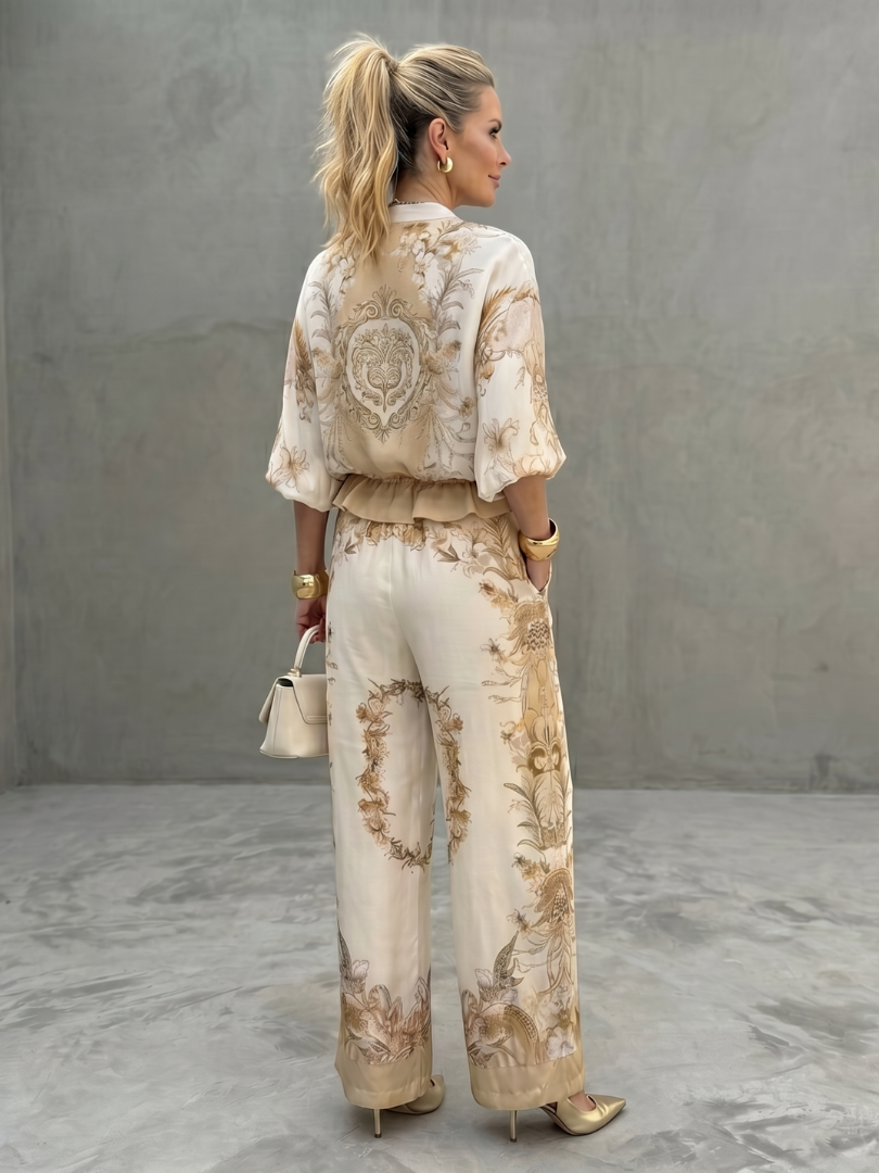 Full view of women's printed zip-front blouse and wide-leg trousers coordinated set