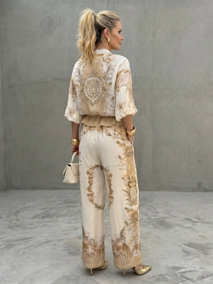 Full view of women's printed zip-front blouse and wide-leg trousers coordinated set