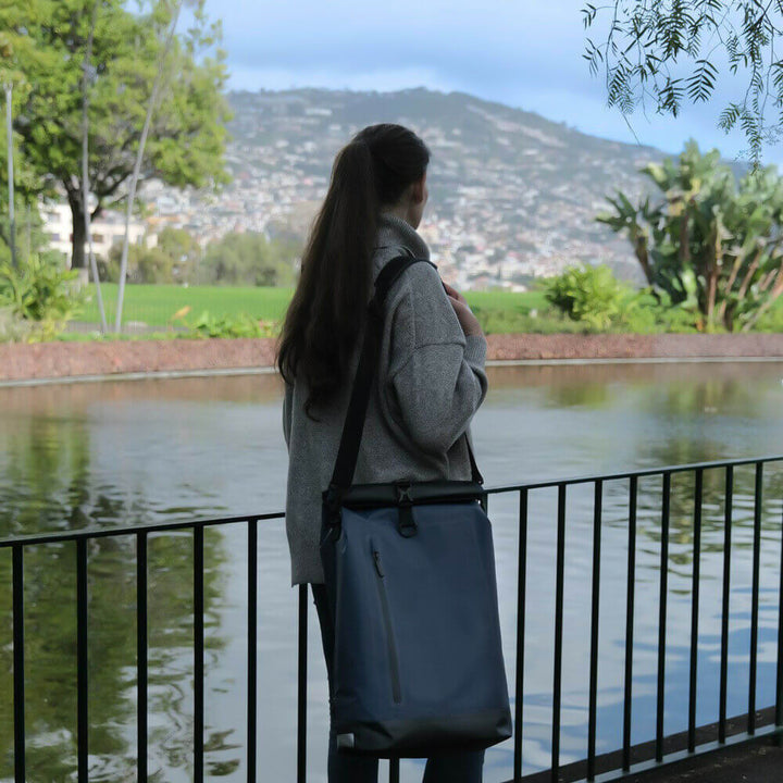 Roll top waterproof bike bag tightly sealed to protect gear from heavy rain