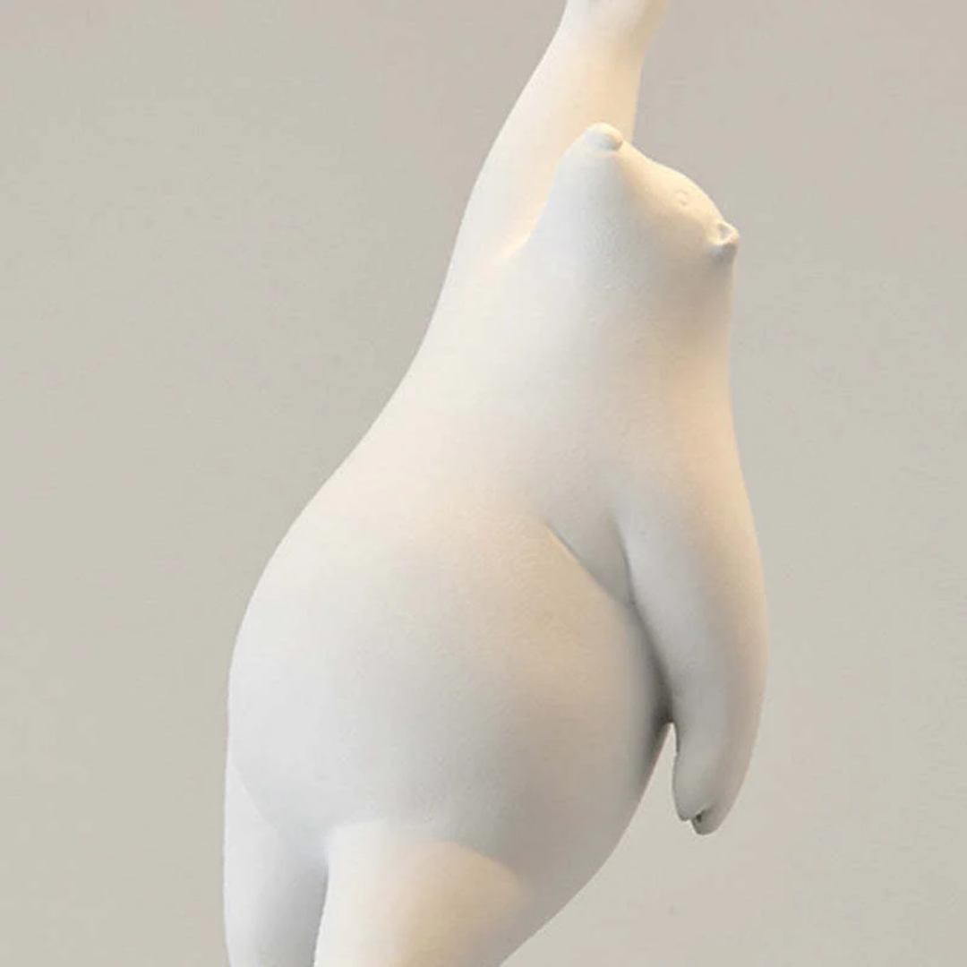 Close-up detail of the white resin bear figurine holding the light fixture
