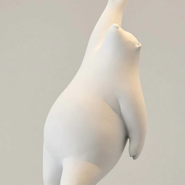 Close-up detail of the white resin bear figurine holding the light fixture
