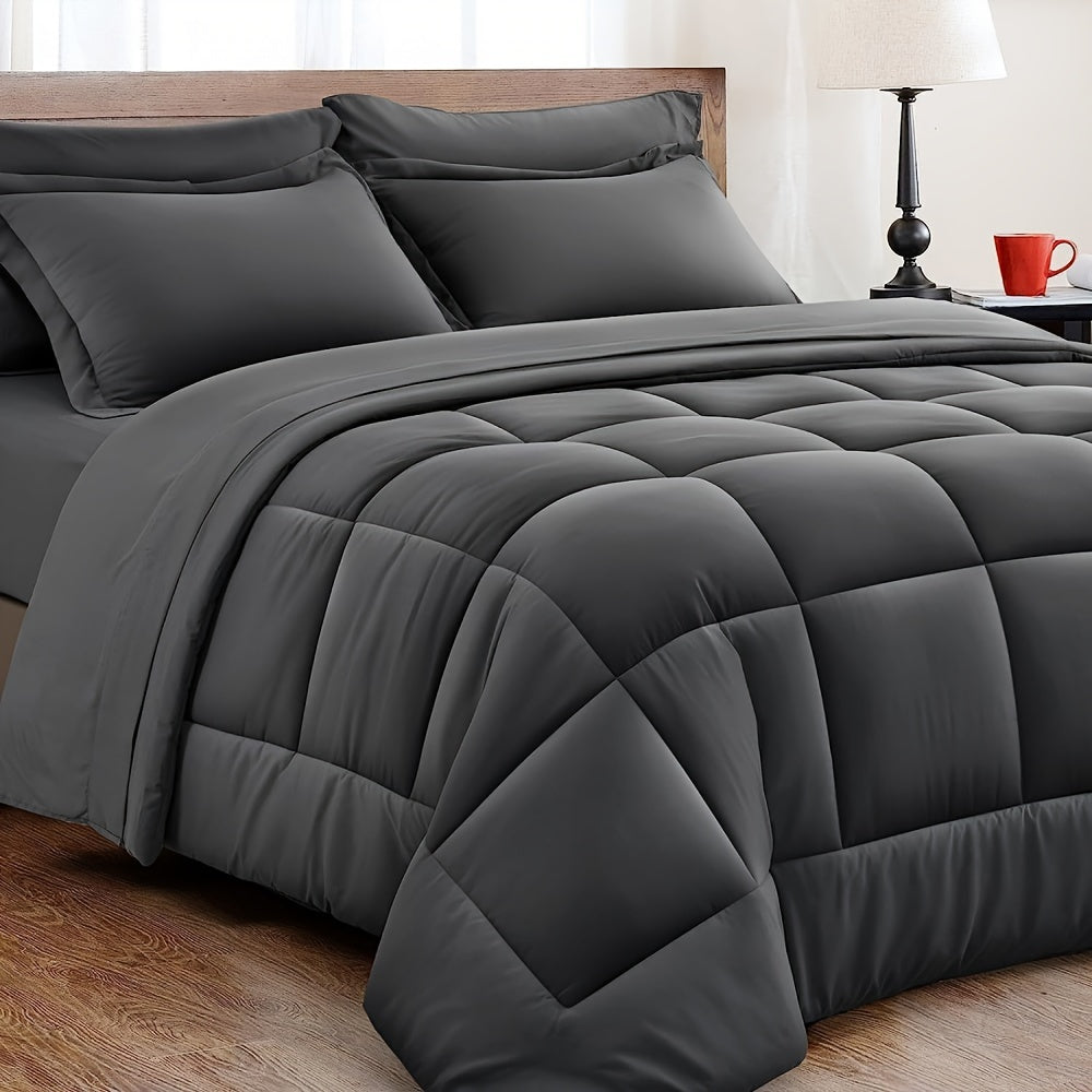 Dark grey 3-piece comforter set displayed neatly on a wooden bed frame