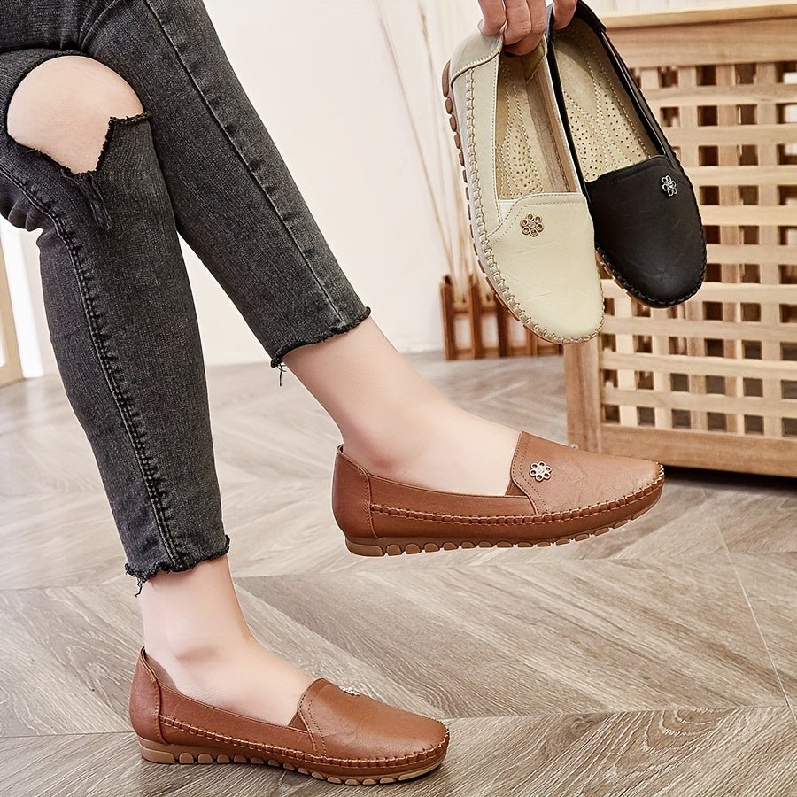 Woman wearing brown casual slip-on loafers with denim jeans