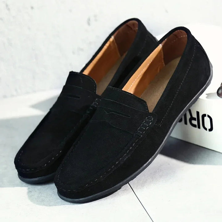 Black men's slip-on casual loafers displayed on a white surface