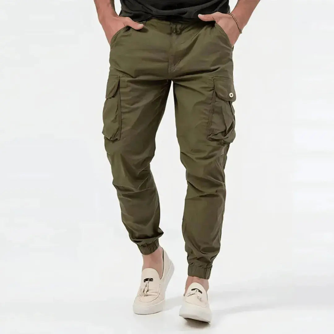 Man wearing olive green Fenix cargo jogger tapered pants