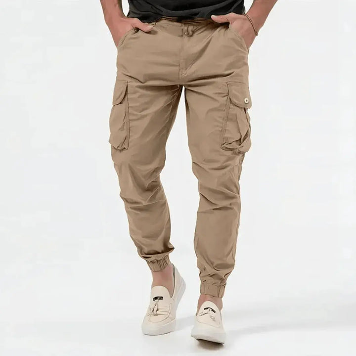 Man wearing beige Fenix cargo jogger tapered pants