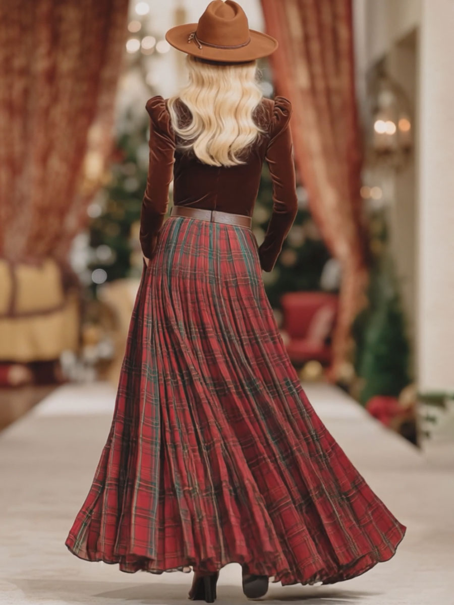 Back view of a woman wearing a brown long sleeve top, red plaid midi skirt, and brown hat.