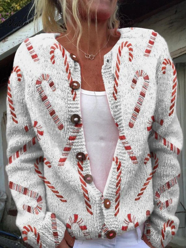 Close-up of a woman wearing a festive candy cane pattern buttoned cardigan sweater with a white top.