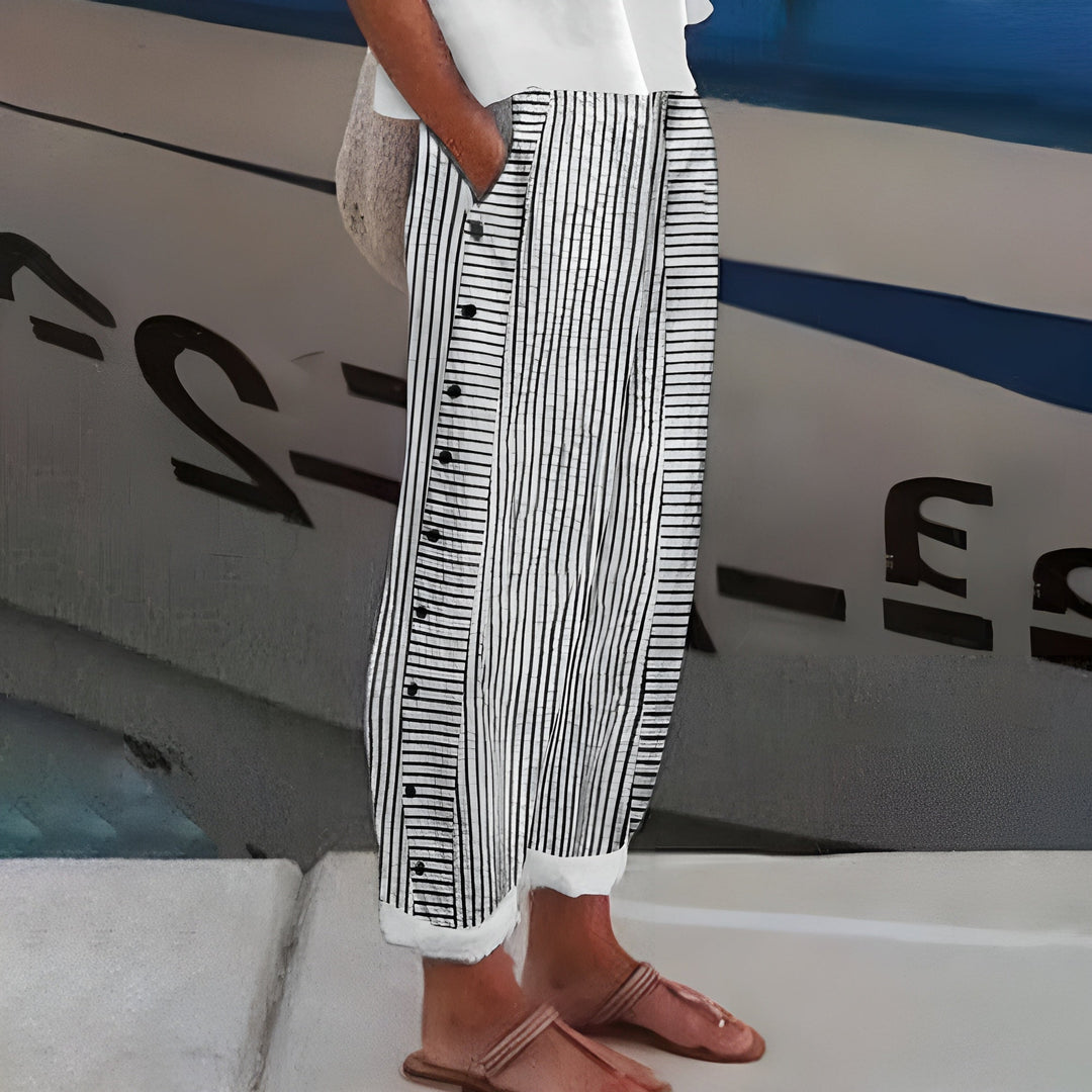 Side profile of black and white striped cropped trousers with relaxed fit