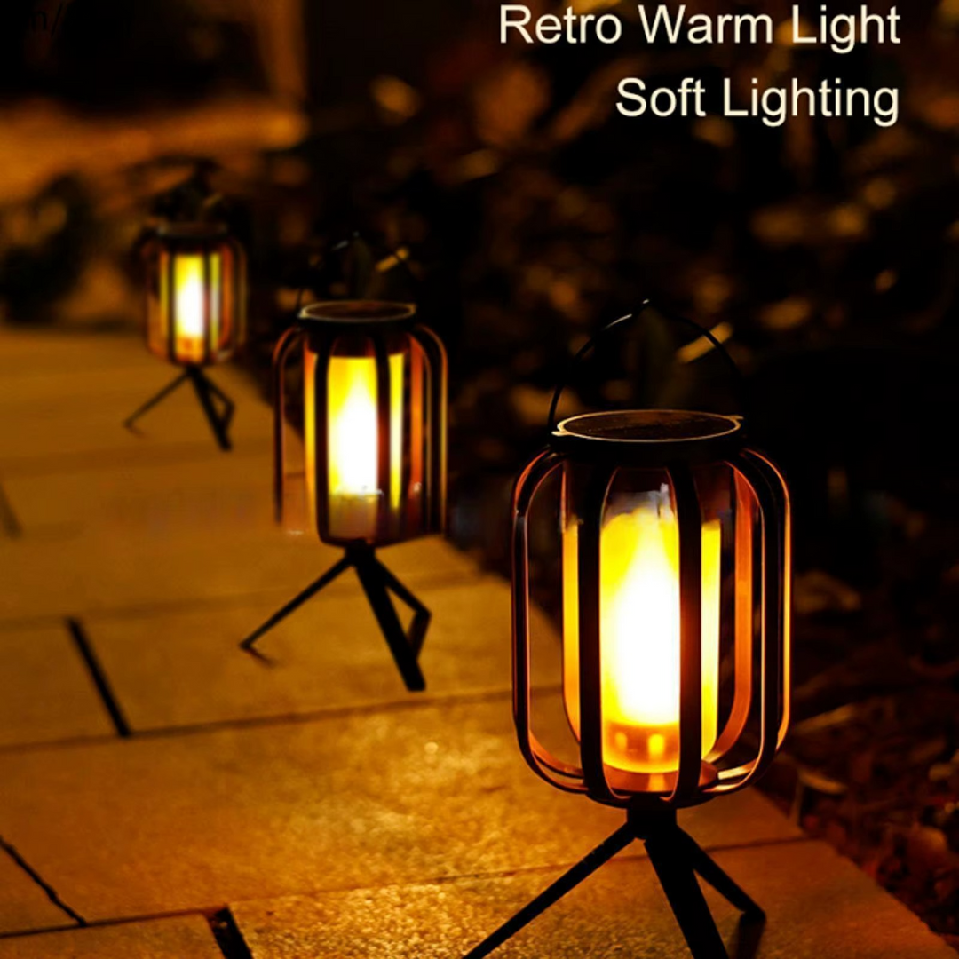 Multiple FlameGlow retro warm light lanterns placed on a pathway at night