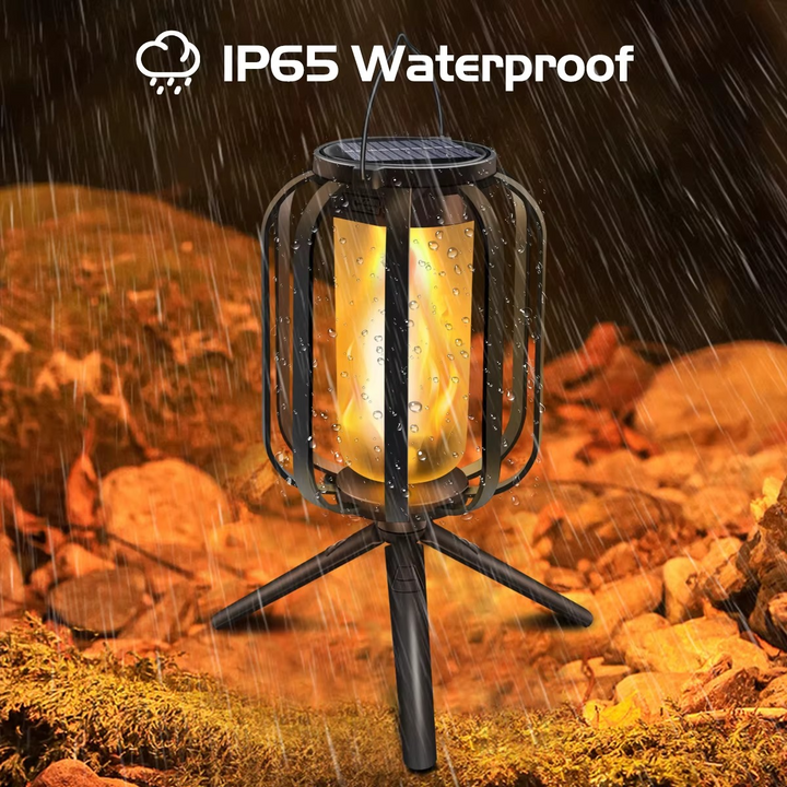 FlameGlow waterproof LED lantern standing on a tripod base during rain