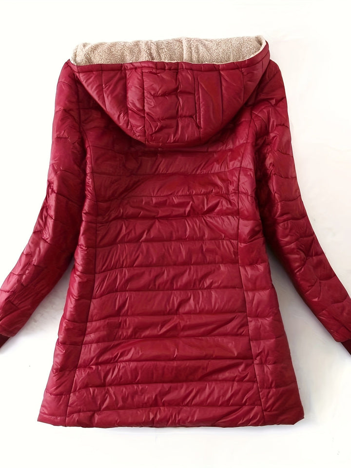 Flat lay of women's winter coat showcasing fleece lining and pockets