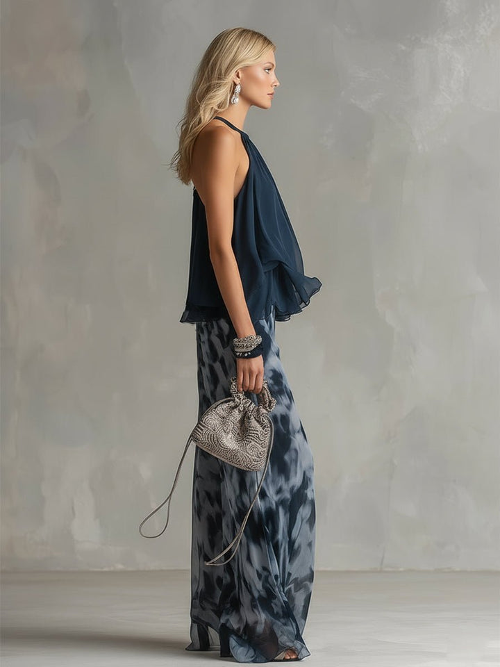 Side profile of a model showcasing the draped halter top and wide leg trousers outfit