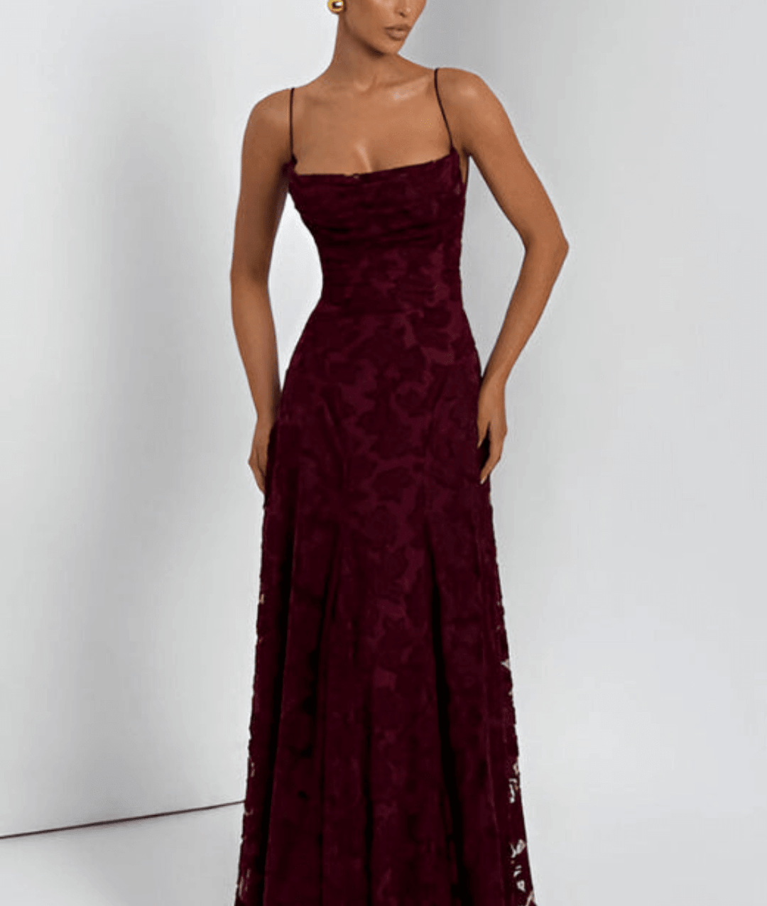 Front view of a woman wearing a cherry red floral maxi dress