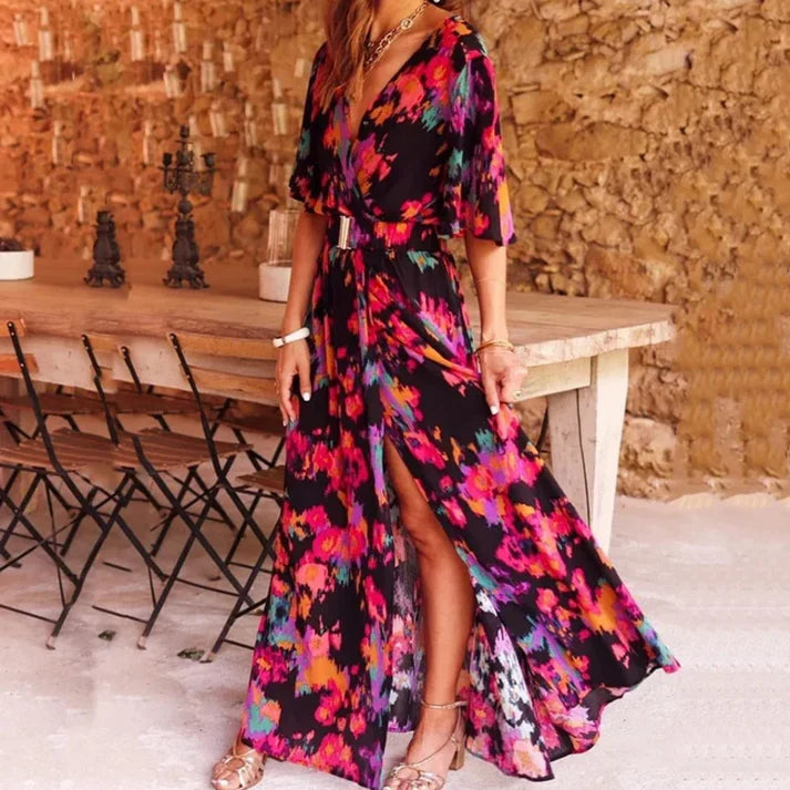 Woman wearing a black and pink floral wrap dress outdoors