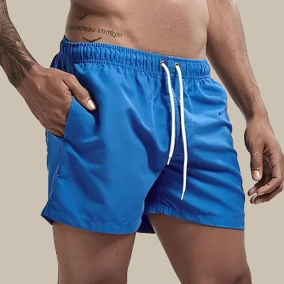 Close-up view of mens swim shorts featuring an adjustable drawstring waistband.