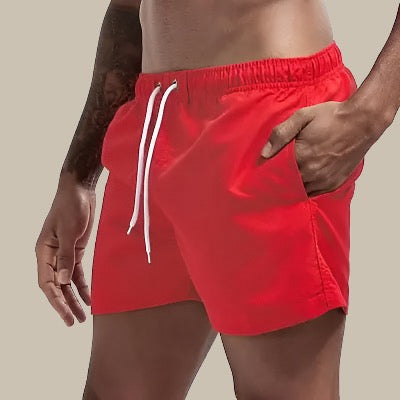 Flat lay of mens drawstring swim shorts showcasing the lightweight summer fabric.
