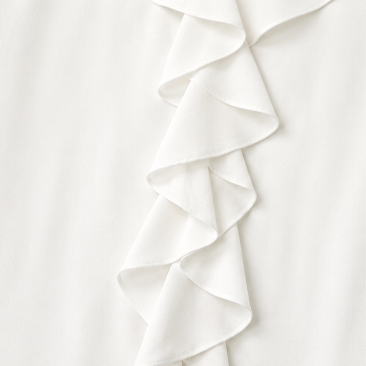 Close-up of the soft fabric and ruffle trim on the trendy blouse