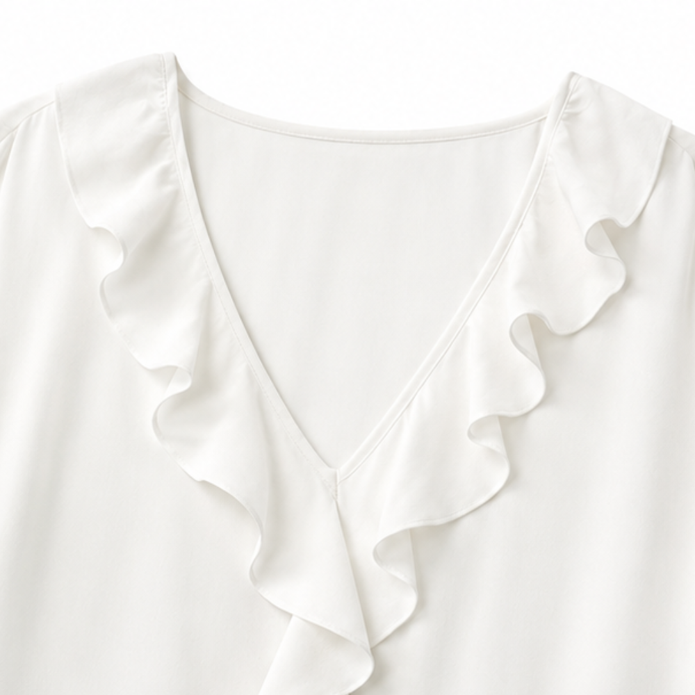 Back view of the solid-colored women's ruffle top and relaxed silhouette