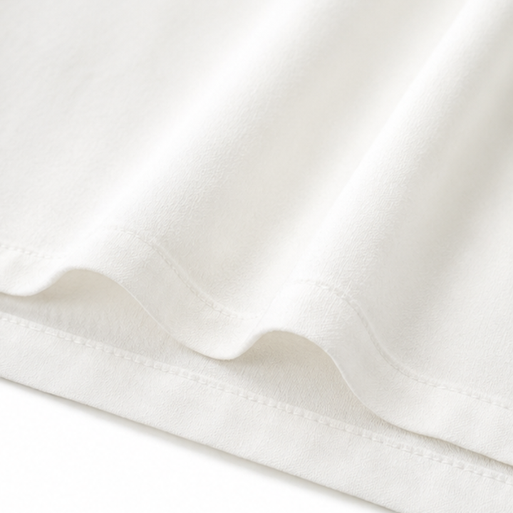 Detailed shot of the textured fabric and 3/4 sleeve cuff on the shirt