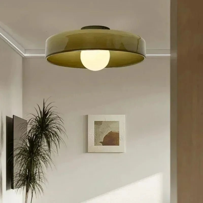 Green glass flush mount ceiling light installed in a modern living room