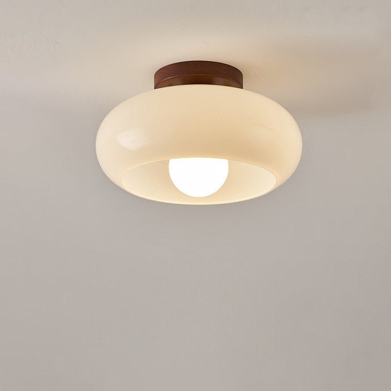 Close-up of Bauhaus flush mount ceiling light with glass shade