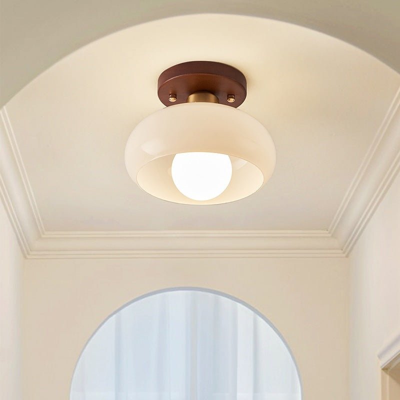 Flush mount light fixture mounted in a bright hallway