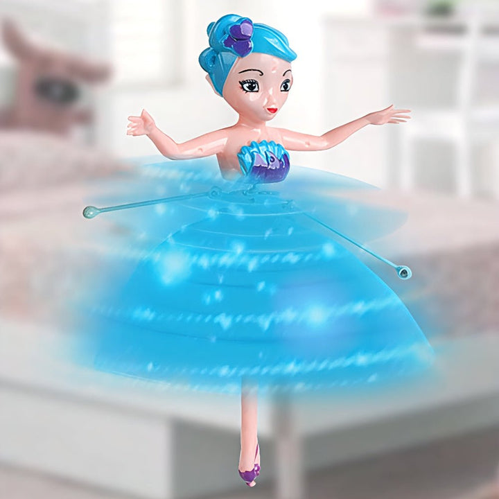 Child playing with motion-controlled flying fairy toy indoors