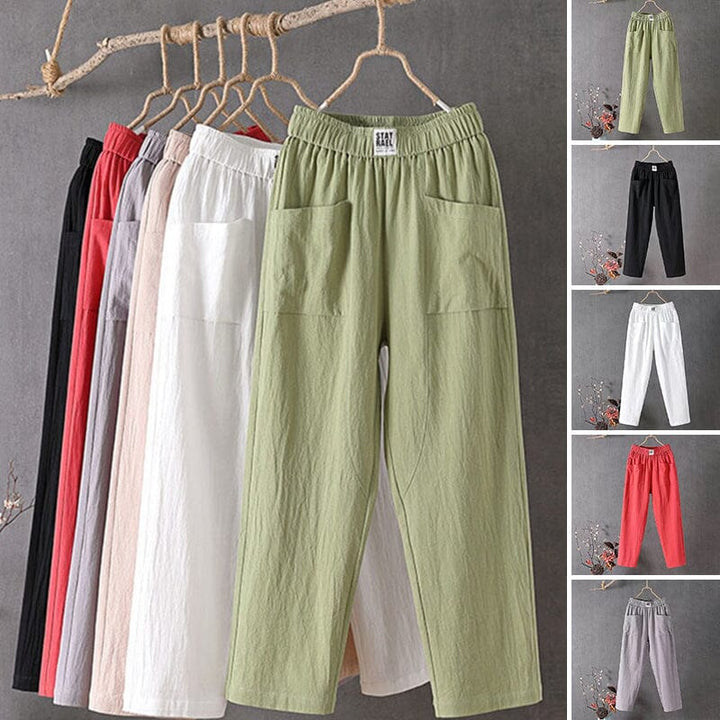 Women's casual trousers in various colors hanging on a rack