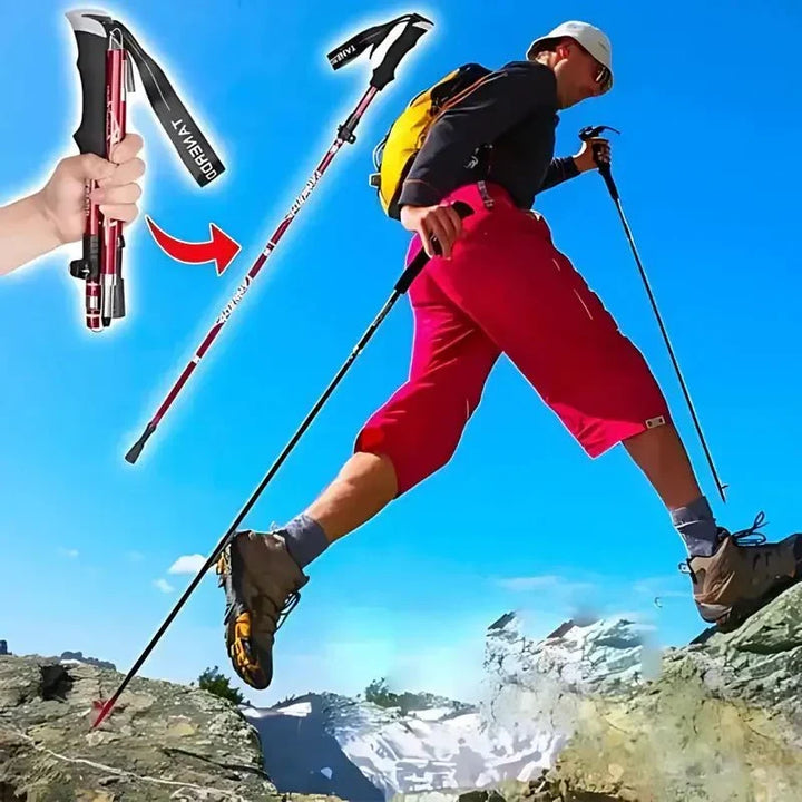 Hiker using a foldable aluminum trekking pole on a rocky mountain trail