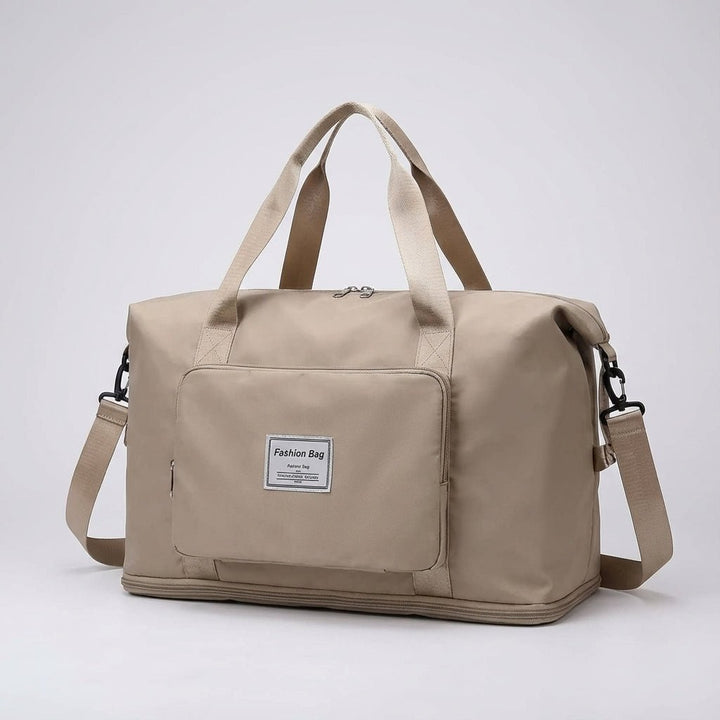 Beige foldable travel bag shown in studio lighting against a neutral background