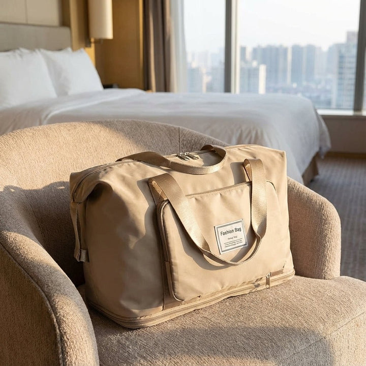Beige travel bag placed on an armchair in a hotel room setting