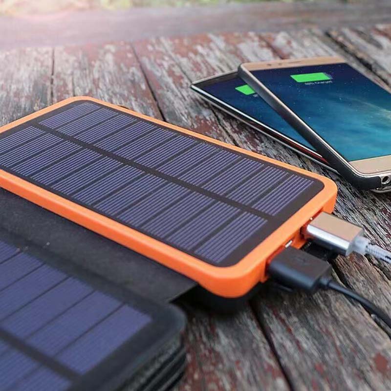 Rugged waterproof power bank connected to a smartphone outdoors