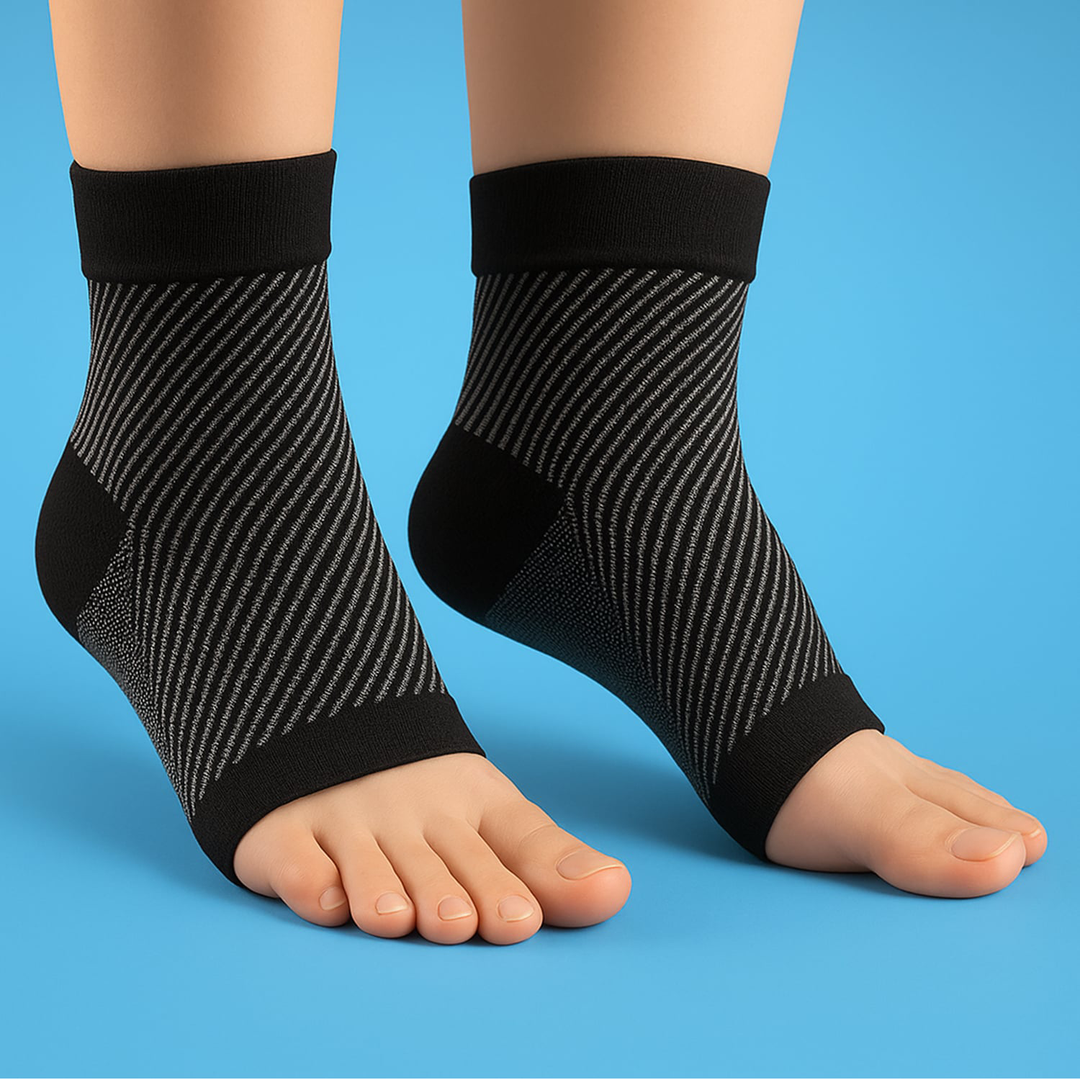 Black unisex foot and ankle compression sleeve socks worn on feet against a blue background