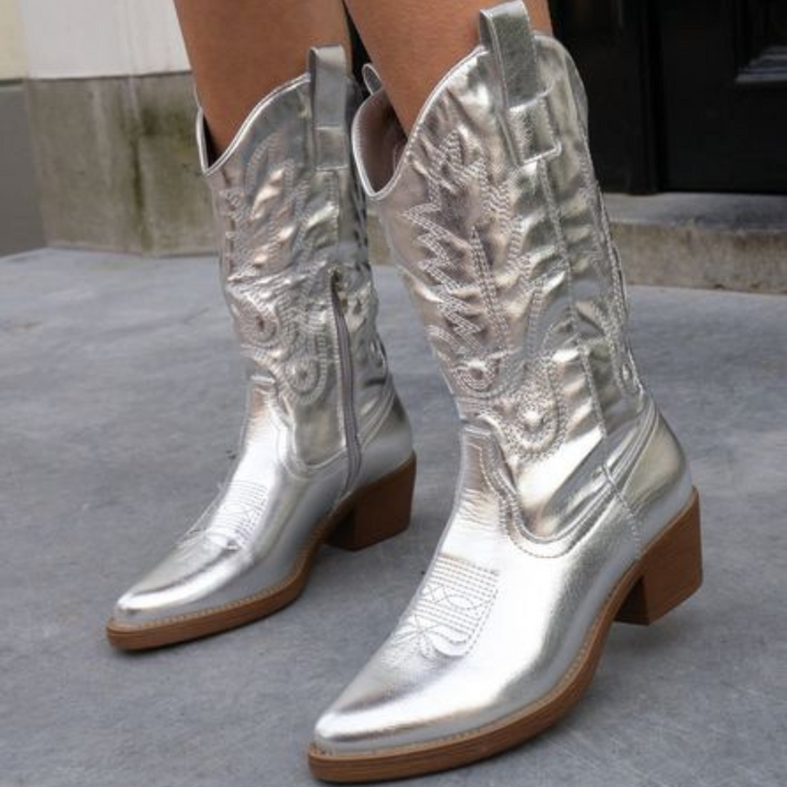 Silver metallic cowboy boots styled outdoors on city streets