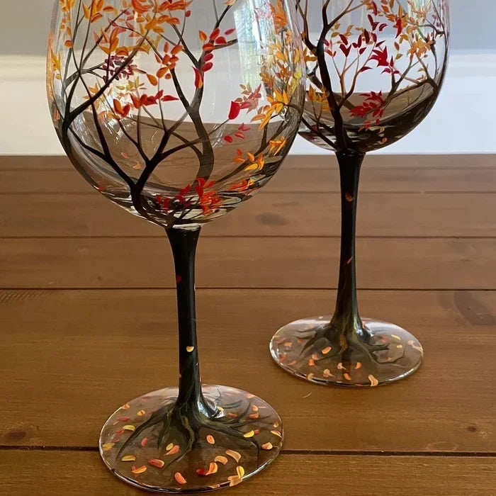 Two hand-painted Autumn tree wine glasses with stems displaying vibrant fall foliage