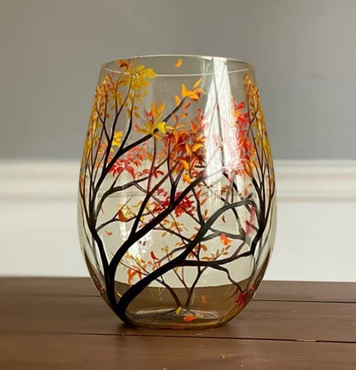 Stemless wine glass featuring vibrant autumn leaf hand-painted tree art