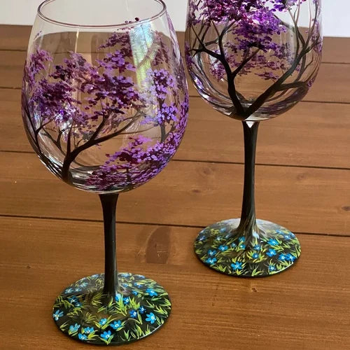 Hand-painted wine glass displaying winter snow tree scene for dining