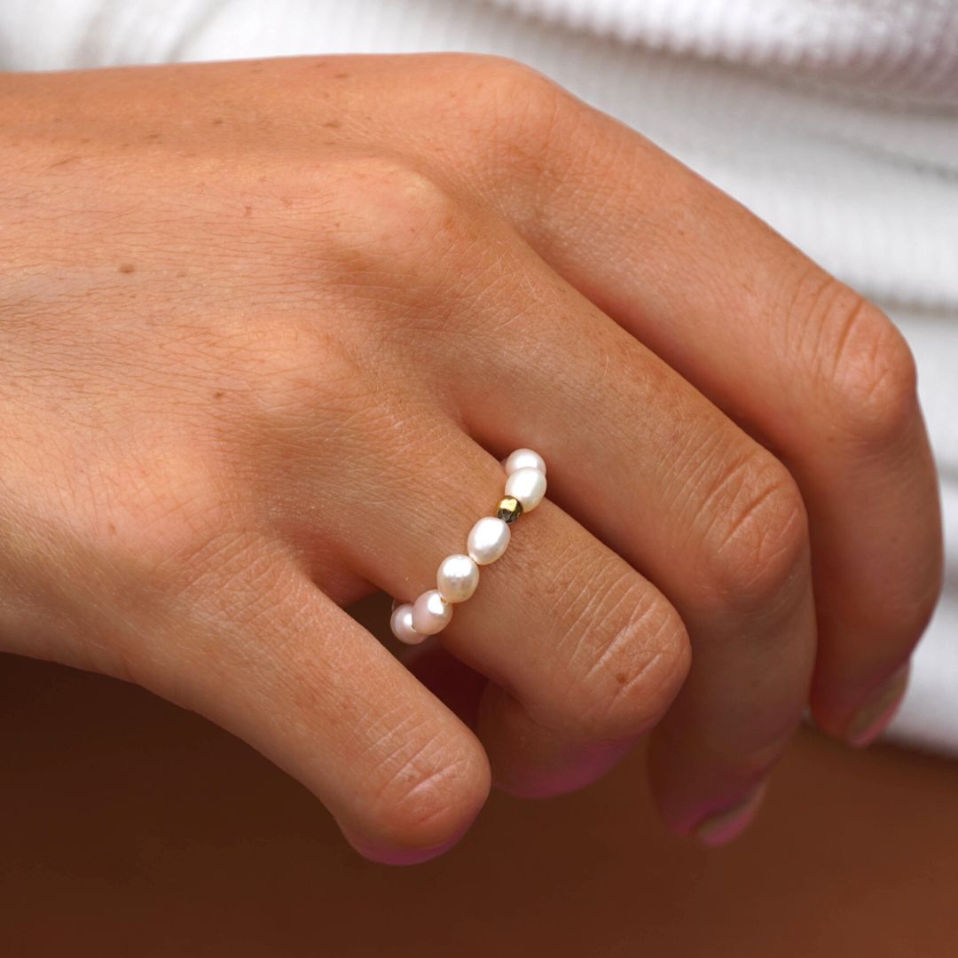 Detailed view of the natural pearl ring worn outdoors