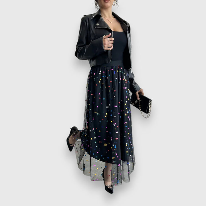 Detailed close-up of polka dot mesh midi skirt fabric showing sheer texture and pattern.