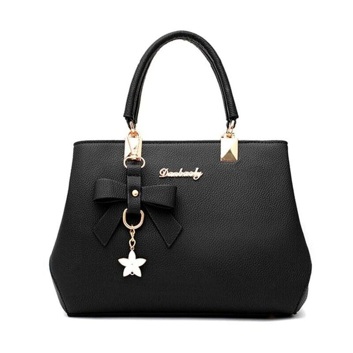 Chic women's shoulder bag with stylish bow accessory and gold hardware