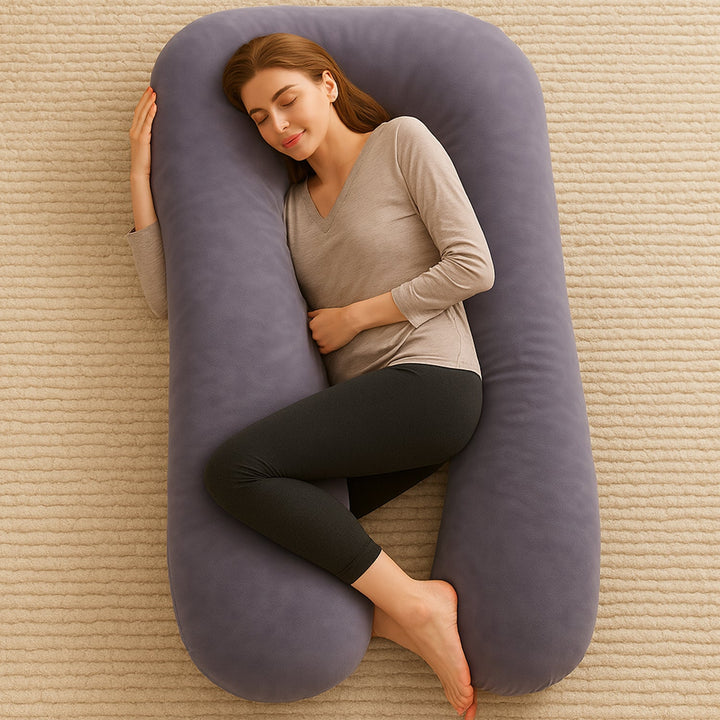 Pregnant woman sleeping comfortably with a large U-shaped maternity pillow