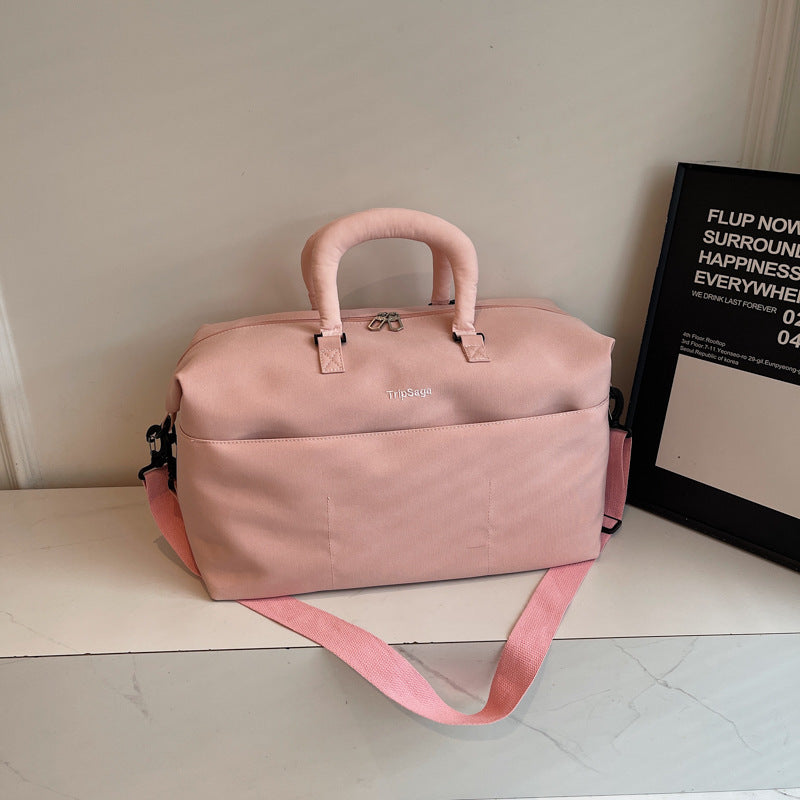 Pink functional travel duffle bag displayed on a clean surface
