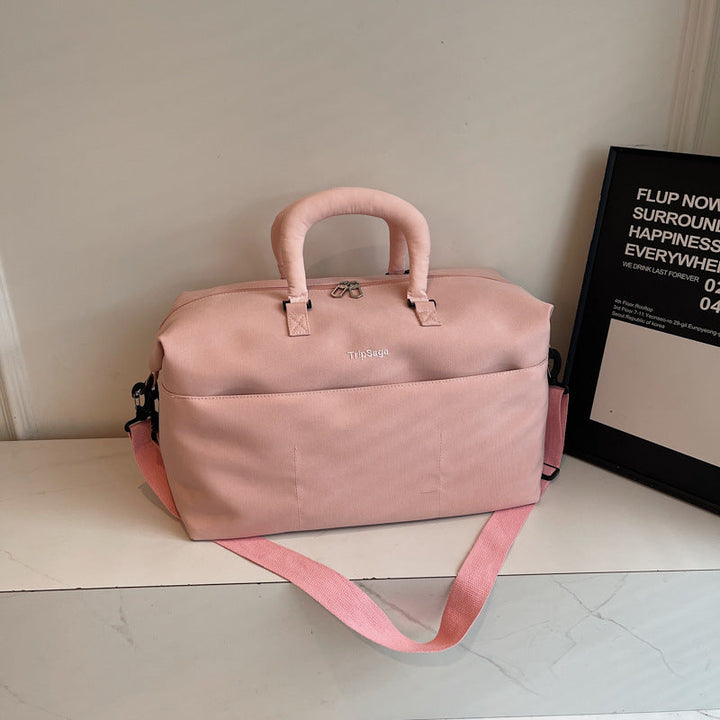 Pink functional travel duffle bag displayed on a clean surface