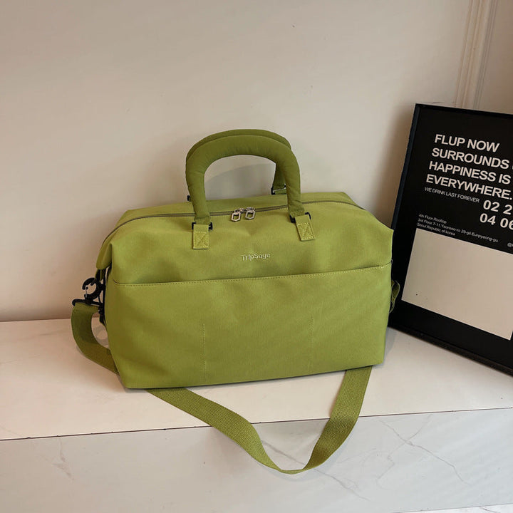 Water-resistant unisex travel duffle bag showing side profile and durable zippers
