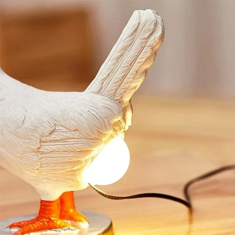 Close-up of the glowing bulb positioned beneath the chicken tail