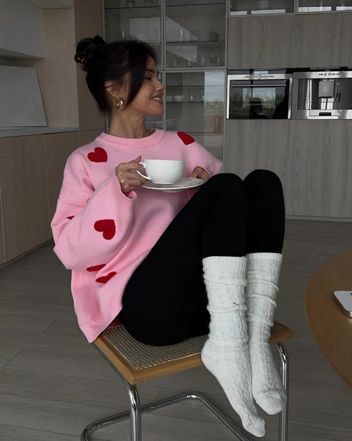 Side profile of women cozy heart patterned pullover sweater in casual style