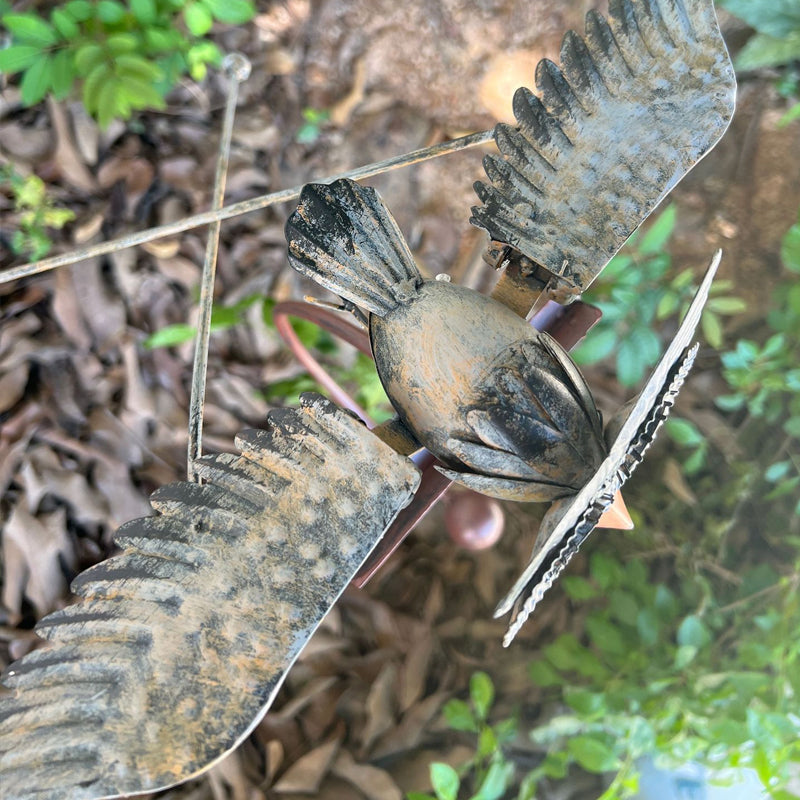 Close-up of kinetic metal bird patio art and ornament