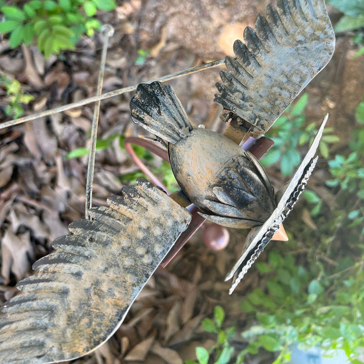 Close-up of kinetic metal bird patio art and ornament